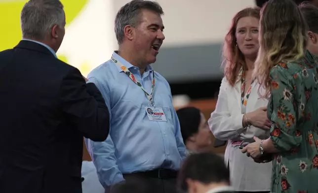 Lars Aagaard, minister for climate, energy and utilities of Denmark, center left, speaks with delegates as he waits for the start of a plenary session at the COP30 U.N. Climate Summit, Saturday, Nov. 22, 2025, in Belem, Brazil. (AP Photo/Andre Penner)