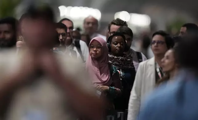 Delegates enter a hall for a plenary session at the COP30 U.N. Climate Summit, Saturday, Nov. 22, 2025, in Belem, Brazil. (AP Photo/Fernando Llano)