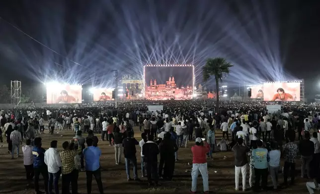 Fans of Tollywood superstar Mahesh Babu arrive to watch unveiling of first look of film "Varanasi" in Hyderabad, India, Saturday, Nov. 15, 2025. (AP Photo/Mahesh Kumar A.)