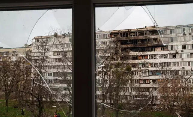 A residential building is seen heavily damaged after a Russian strike on Kyiv, Ukraine, on Tuesday, Nov. 25, 2025. (AP Photo/Evgeniy Maloletka)