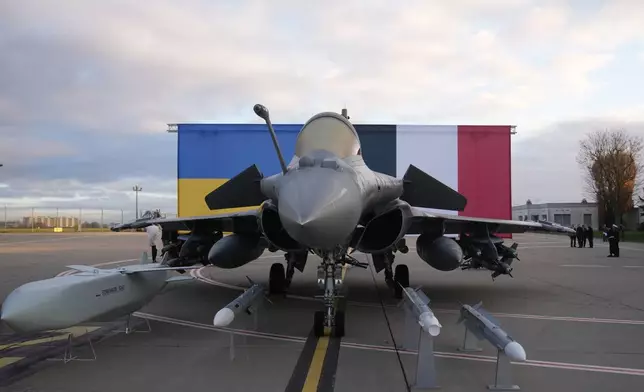 A Rafale jet fighter is seen before the arrival of Ukrainian President Volodymyr Zelenskyy Monday, Nov. 17, 2025 at the Villacoublay air base near Paris. (AP Photo/Christophe Ena, Pool)