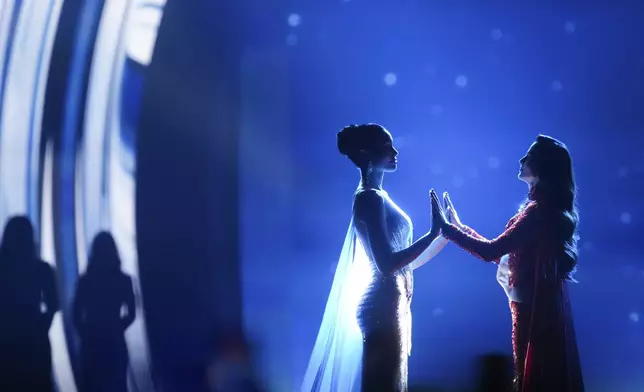 Miss Mexico Fatima Bosch, right, and Miss Thailand Praveenar Singh hold hands while waiting for the announcement of winner for the 2025 Miss Universe pageant in Nonthaburi, north of Bangkok, in Nonthaburi province, Thailand, Friday, Nov. 21, 2025. (AP Photo/Sakchai Lalit)