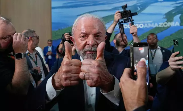 Brazil President Luiz Inacio Lula da Silva flashes two thumbs-up during the COP30 U.N. Climate Summit in Belem, Brazil, Friday, Nov. 7, 2025. (AP Photo/Eraldo Peres)