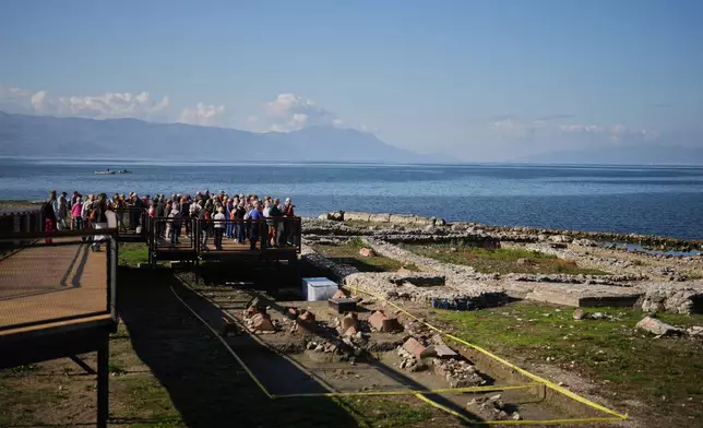 French pilgrims look at archaeological excavations of the ancient Byzantine-era Christian Saint Neophytos Basilica, in Iznik, also known by its ancient name Nicaea, northwestern Turkey, Thursday, Nov. 13, 2025, ahead of the visit of Pope Leo XIV to mark the 1,700th anniversary of the First Council of Nicaea. (AP Photo/Francisco Seco)