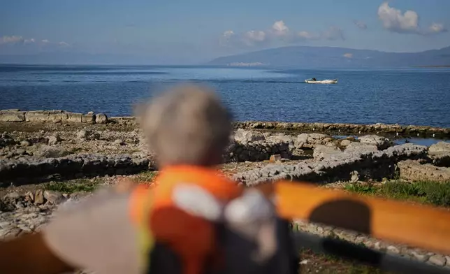 A man sails a boat next to archaeological excavations of the ancient Byzantine-era Christian Saint Neophytos Basilica, in Iznik, also known by its ancient name Nicaea, northwestern Turkey, Thursday, Nov. 13, 2025, ahead of the visit of Pope Leo XIV to mark the 1,700th anniversary of the First Council of Nicaea. (AP Photo/Francisco Seco)