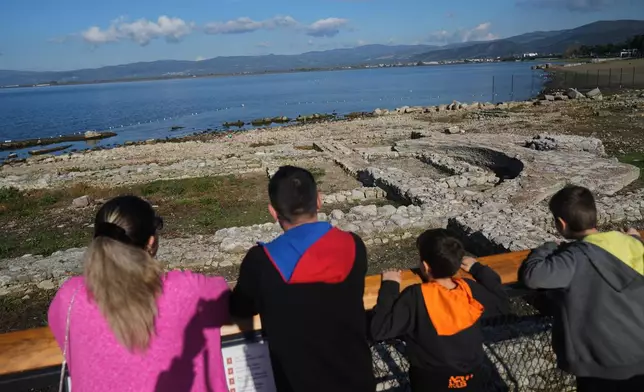 Visitors look at archaeological excavations of the ancient Byzantine-era Christian Saint Neophytos Basilica, in Iznik, also known by its ancient name Nicaea, northwestern Turkey, Thursday, Nov. 13, 2025, ahead of the visit of Pope Leo XIV to mark the 1,700th anniversary of the First Council of Nicaea. (AP Photo/Francisco Seco)
