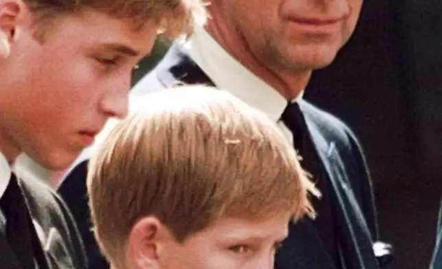 FILE - Britain's Prince Charles casts a concerned glance towards his sons Prince William, left, and Prince Harry as they wait for the coffin of Princess Diana to be loaded into a hearse outside Westminster Abbey in London., Sept. 6, 1997. (AP Photo/John Gaps III, File)