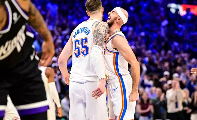 Oklahoma City Thunder guard Alex Caruso (9), right, celebrates with Oklahoma City Thunder center/forward Isaiah Hartenstein (55) during the second half of an NBA basketball game between Sacramento Kings and Oklahoma City Thunder, Tuesday, Oct. 28, 2025, in Oklahoma City. (AP Photo/Gerald Leong)