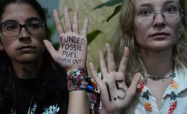 Activists participate in a demonstration outside where negotiations are taking place at the COP30 U.N. Climate Summit, Friday, Nov. 21, 2025, in Belem, Brazil. (AP Photo/Joshua A. Bickel)