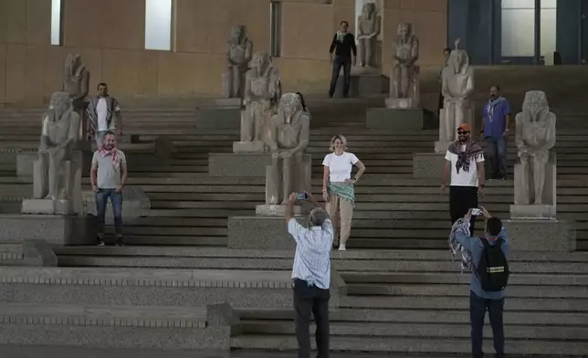 Tourists pose at the Grand staircase at the Grand Egyptian Museum in Giza, Egypt, Friday, May 23, 2025. (AP Photo/Amr Nabil)