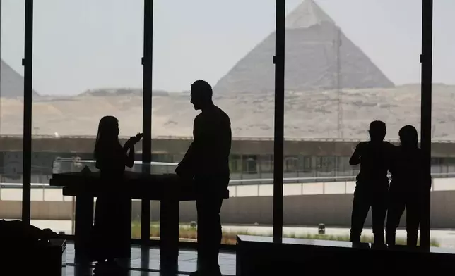 Tourists view the site of the great Pyramids from the rest zone of the Grand Egyptian Museum in Giza, Egypt, Friday, May 23, 2025. (AP Photo/Amr Nabil)