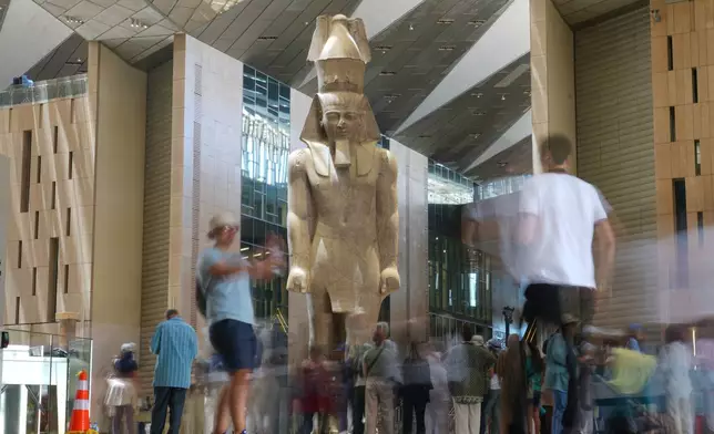 Tourists view the statue of Pharaoh Ramses II, at the Grand Egyptian Museum in Giza, Egypt, Friday, May 23, 2025. (AP Photo/Amr Nabil)