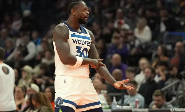 Minnesota Timberwolves forward Julius Randle reacts after scoring against the Phoenix Suns during the first half of an NBA Cup basketball game, Friday, Nov. 21, 2025, in Phoenix. (AP Photo/Rick Scuteri)