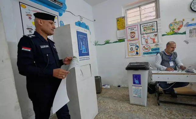 An Iraqi policeman casts his vote during the early voting for security forces ahead of Tuesday's parliamentary election in Baghdad, Iraq, Sunday, Nov. 11, 2025. (AP Photo/Hadi Mizban)