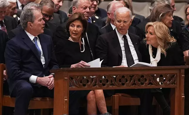 Former Presidents front row from left, George W. Bush with Laura Bush and Joe Biden with Jill Biden, talk together before the funeral service for former Vice President Dick Cheney at the Washington National Cathedral on Thursday, Nov. 20, 2025 in Washington. (AP Photo/Matt Rourke)