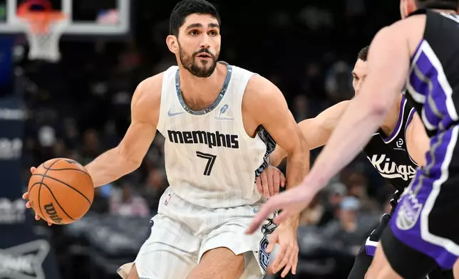 Memphis Grizzlies forward Santi Aldama (7) handles the ball against Sacramento Kings guard Zach LaVine in the first half of an NBA basketball game, Thursday, Nov. 20, 2025, in Memphis, Tenn. (AP Photo/Brandon Dill)