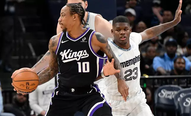 Sacramento Kings guard DeMar DeRozan (10) handles the ball against Memphis Grizzlies forward Cedric Coward (23) in the first half of an NBA basketball game Thursday, Nov. 20, 2025, in Memphis, Tenn. (AP Photo/Brandon Dill)