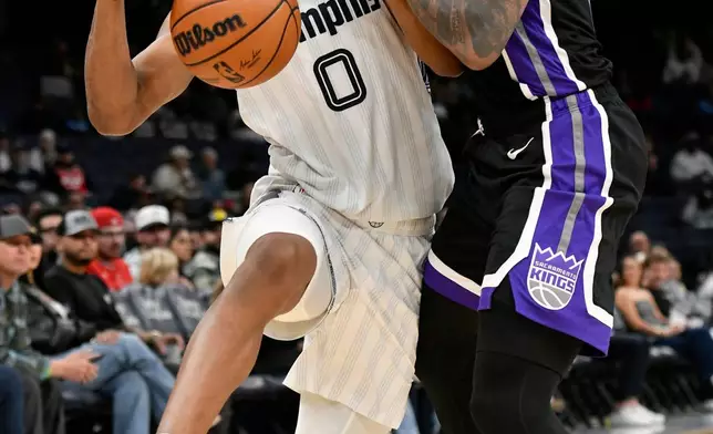 Memphis Grizzlies forward Jaylen Wells (0) runs into Sacramento Kings guard DeMar DeRozan, right, in the first half of an NBA basketball game Thursday, Nov. 20, 2025, in Memphis, Tenn. (AP Photo/Brandon Dill)