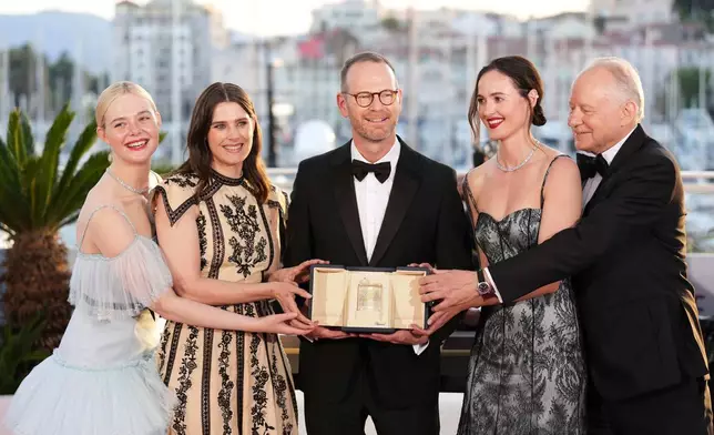 FILE - Director Joachim Trier, center, winner of the grand prix for the film "Sentimental Value," poses with Elle Fanning, from left, Inga Ibsdotter Lilleaas, Renate Reinsve and Stellan Skarsgard at the 78th international film festival, Cannes, southern France, on May 24, 2025. (Photo by Scott A Garfitt/Invision/AP, File)
