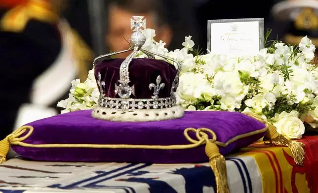 FILE - The Koh-i-Noor diamond, set in the Maltese Cross at the front of the crown made for Britain's late Queen Mother, is seen on her coffin as it is drawn to London's Westminster Hall on April 5, 2002. (AP Photo/Alastair Grant, File)