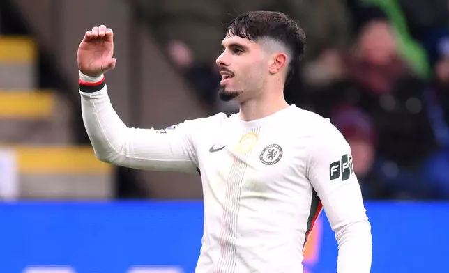 Chelsea's Pedro Neto celebrates after scoring the opening goal during the English Premier League soccer match between Burnley v Chelsea, in Burnley, England, Saturday, Nov. 22, 2025. (Gary Oakley/PA via AP)