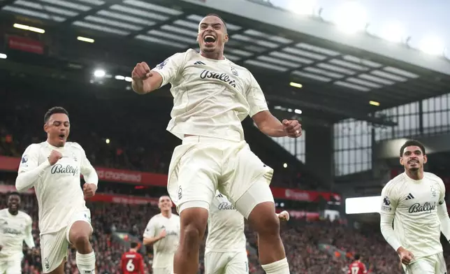 Nottingham Forest's Murillo, centre, celebrates after scoring his side's opening goal during the English Premier League soccer match between Liverpool and Nottingham Forest in Liverpool, England, Saturday, Nov. 22, 2025. (AP Photo/Ian Hodgson)