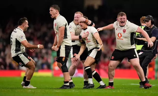 Wales' Jarrod Evans, 2nd right, celebrates after the final whistle of the rugby union Nations Series match between Wales and Japan at the Principality Stadium, Cardiff, Saturday, Nov. 15, 2025. (Andrew Matthews/PA via AP)