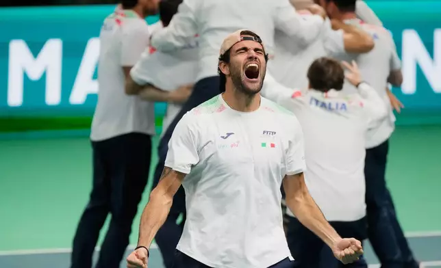 Italy's Matteo Berrettini, front, celebrates after Italy's Flavio Cobolli winning a Davis Cup final singles tennis match against Spain's Jaume Munar, in Bologna, Italy, Sunday, Nov. 23, 2025. (AP Photo/Luca Bruno)