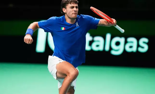 Italy's Flavio Cobolli celebrates after winning a set point against Spain's Jaume Munar during a Davis Cup final singles tennis match between Italy and Spain, in Bologna, Italy, Sunday, Nov. 23, 2025. (AP Photo/Luca Bruno)
