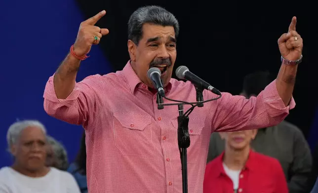 Venezuelan President Nicolas Maduro addresses civilians taking an oath to join a state-organized defense network in the Petare neighborhood of Caracas, Venezuela, Saturday, Nov. 15, 2025. (AP Photo/Ariana Cubillos)