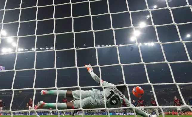 AC Milan's goalkeeper Mike Maignan saves a penalty kick during the Serie A soccer match between Inter Milan and AC Milan in Milan, Italy, Sunday, Nov. 23, 2025. (AP Photo/Antonio Calanni)