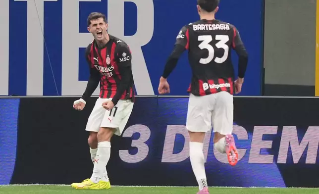 AC Milan's Christian Pulisic celebrates after scoring during the Serie A soccer match between Inter Milan and AC Milan in Milan, Italy, Sunday, Nov. 23, 2025. (AP Photo/Antonio Calanni)