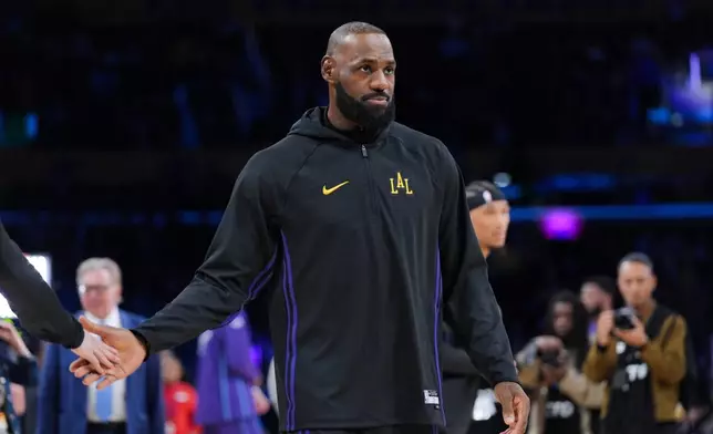 Los Angeles Lakers forward LeBron James warms up before the team's NBA basketball game against the Utah Jazz Tuesday, Nov. 18, 2025, in Los Angeles. (AP Photo/Jae C. Hong)