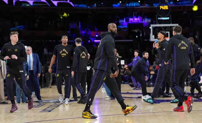 Los Angeles Lakers forward LeBron James warms up before the team's NBA basketball game against the Utah Jazz Tuesday, Nov. 18, 2025, in Los Angeles. (AP Photo/Jae C. Hong)