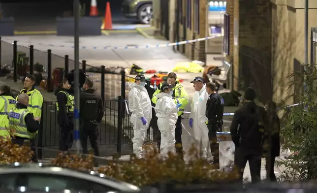 Emergency responders at Huntingdon station after a mass stabbing on a London-bound train in eastern England, in Cambridgeshire, England, Saturday, Nov. 1, 2025. (Chris Radburn/PA via AP)