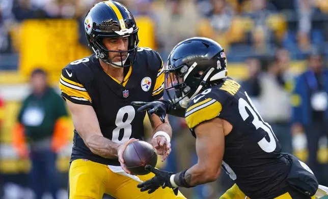 Pittsburgh Steelers quarterback Aaron Rodgers (8) hands off to running back Jaylen Warren (30) during the second half of an NFL football game against the Indianapolis Colts in Pittsburgh, Sunday, Nov. 2, 2025. (AP Photo/Matt Freed)