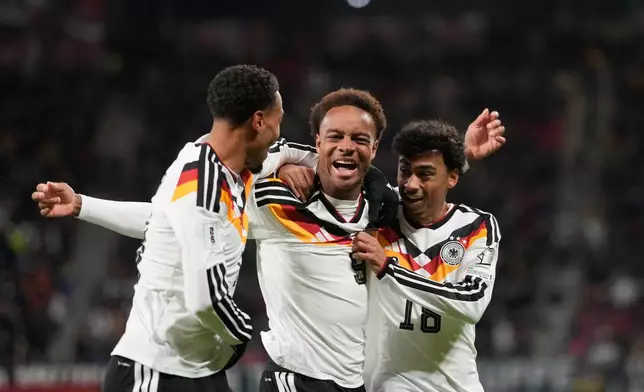 Germany's Assan Ouedraogo, center, celebrates after scoring during a group A World Cup qualifiying soccer match between Germany and Slovakia in Leipzig, Germany, Monday, Nov. 17, 2025. (AP Photo/Matthias Schrader)