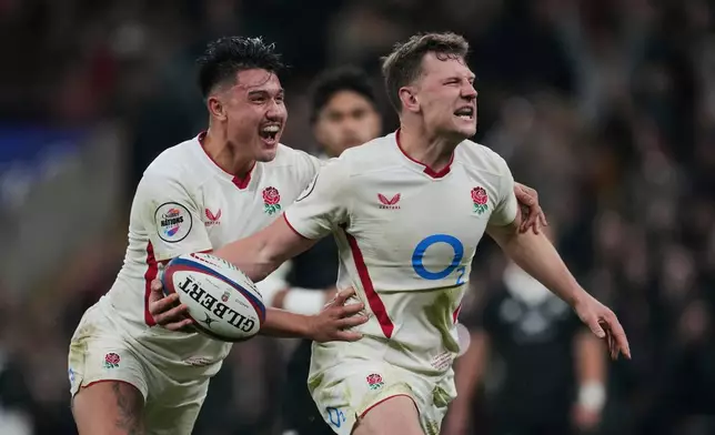 England Fraser Dingwall, right, celebrates with teammate Marcus Smith, after scoring a try during the rugby union Nations Series match between England and New Zealand in London, Saturday, Nov. 15, 2025. (AP Photo/Kin Cheung)
