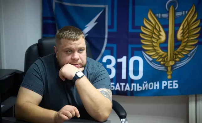 Commander of the 310th Battalion, Dmytro Liashok, a 16-year military veteran and one of Ukraine's early pioneers in electronic warfare, talks with the Associated Press in the frontline city of Kherson, Southern Ukraine, Sunday, Nov. 2, 2025. (AP Photo/Efrem Lukatsky)