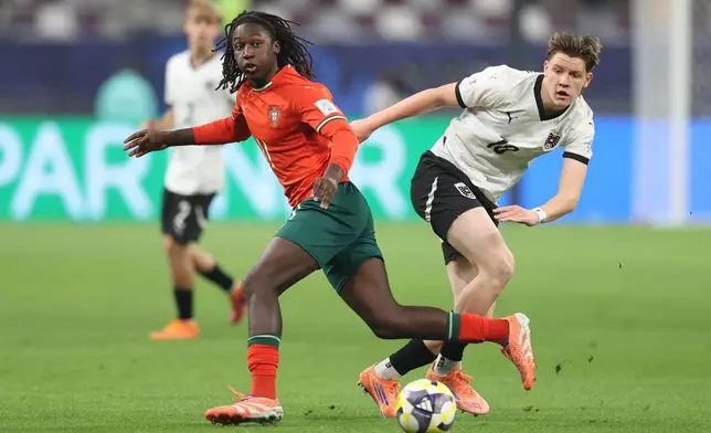 Portugal's Stevan, left, and Austria's Luca Weinhandl look at the ball during the FIFA U17 World Cup final soccer match between Portugal and Austria in Doha, Qatar, on Thursday, Nov. 27, 2025. (AP Photo/Hussein Sayed)