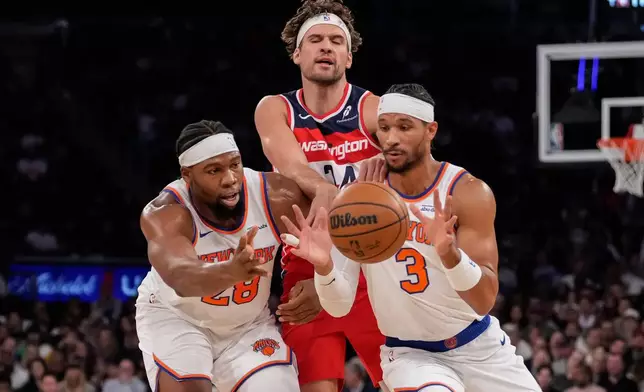 New York Knicks forward Guerschon Yabusele (28) and New York Knicks guard Josh Hart (3) drives past Washington Wizards forward Corey Kispert (24) during the first half of an NBA basketball game, Monday, Nov. 3, 2025, in New York. (AP Photo/Yuki Iwamura)