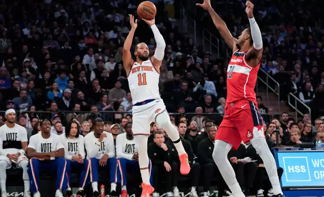 New York Knicks guard Jalen Brunson (11) shoots over Washington Wizards center Alex Sarr (20) during the first half of an NBA basketball game, Monday, Nov. 3, 2025, in New York. (AP Photo/Yuki Iwamura)