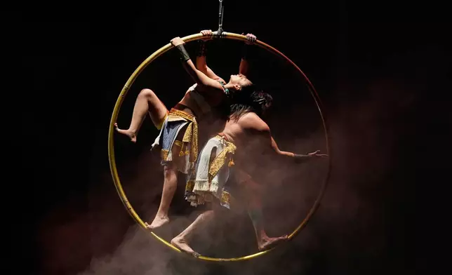 Acrobats from a Mexican theater company perform the show titled "Mortal Leap into Xibalba," which reinterprets a myth from a sacred Mayan book about creation and the journey to the underworld, in Mexico City, Saturday, Nov. 22, 2025. (AP Photo/Marco Ugarte)