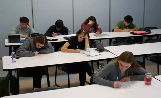 Students take a test during a class at Nueta Hidatsa Sahnish College, Thursday, Oct. 30, 2025, in New Town, N.D. (AP Photo/John Locher)