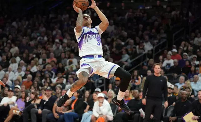 Utah Jazz guard Keyonte George (3) scores against the Phoenix Suns during the second half of an NBA Cup basketball game, Friday, Oct. 31, 2025, in Phoenix. (AP Photo/Rick Scuteri)