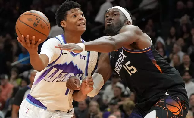 Utah Jazz forward Ace Bailey drives on Phoenix Suns center Mark Williams (15) during the second half of an NBA Cup basketball game, Friday, Oct. 31, 2025, in Phoenix. (AP Photo/Rick Scuteri)