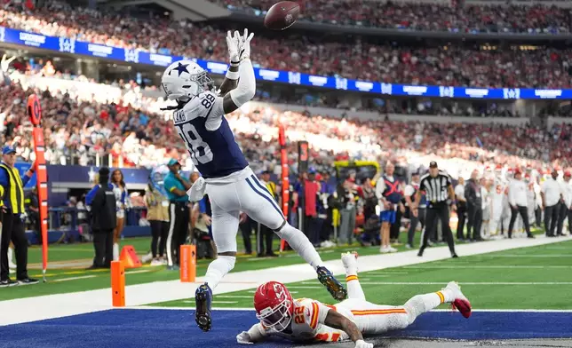Dallas Cowboys wide receiver CeeDee Lamb (88) catches a touchdown pass as Kansas City Chiefs cornerback Trent McDuffie (22) defends during the first half of an NFL football game Thursday, Nov. 27, 2025, in Arlington, Texas. (AP Photo/Tony Gutierrez)