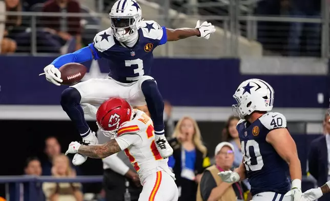 Dallas Cowboys wide receiver George Pickens (3) leaps over Kansas City Chiefs cornerback Trent McDuffie (22) during the second half of an NFL football game Thursday, Nov. 27, 2025, in Arlington, Texas. (AP Photo/Tony Gutierrez)
