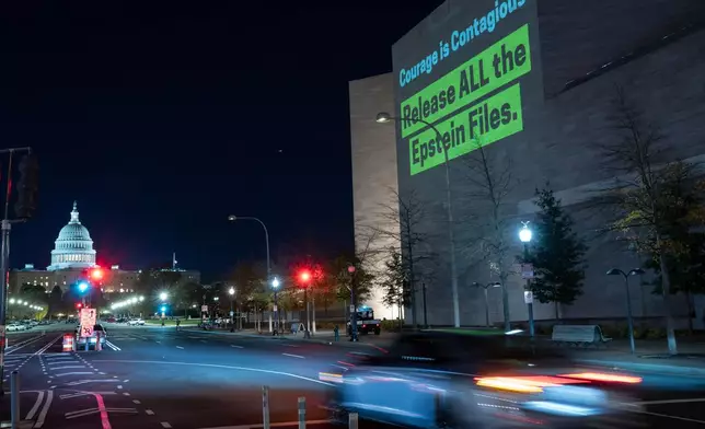 A World Without Exploitation projection is seen on the wall of the National Gallery of Art calling on Congress to vote yes on the Epstein files transparency act in Washington, Monday, Nov. 17, 2025. (AP Photo/Jose Luis Magana)