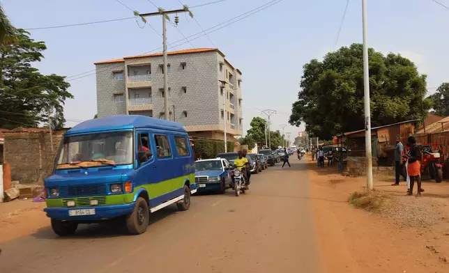 Cars drive on the street in Bissau, Guinea-Bissau, Wednesday, Nov. 26, 2025. (AP Photo/Darcicio Barbosa)